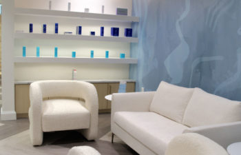 A waiting area and a display shelf with skincare products offered for sale at Kalos Hair Transplant, LLC in Atlanta GA.