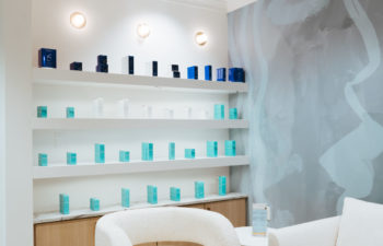 A waiting area and a display shelf with skincare products offered for sale at Kalos Hair Transplant, LLC in Atlanta GA.