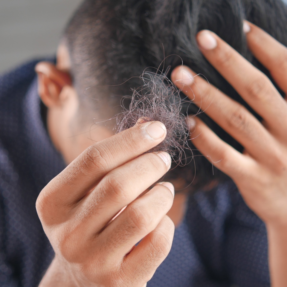 man hold his list hair close up