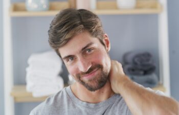 Portrait, smile and skincare with man in bathroom for beauty, morning routine and pride. Self care, dermatology and beard grooming with male person in home for confidence, hygiene and aesthetic